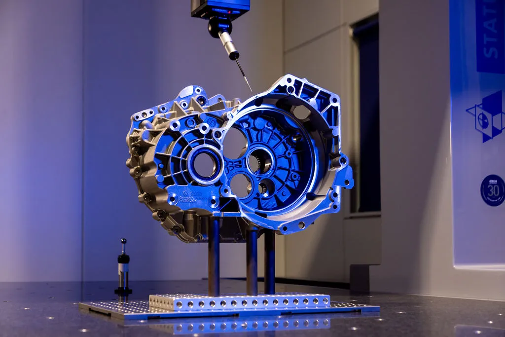 CMM probe inspecting a machined component at Status Metrology